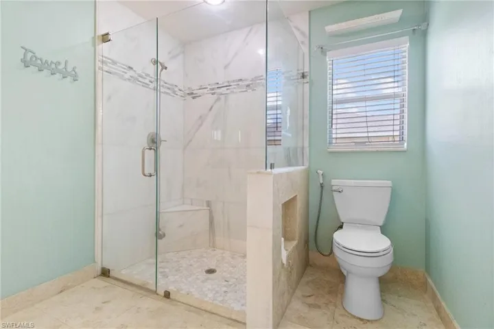 Full bathroom featuring a stall shower and tile patterned flooring