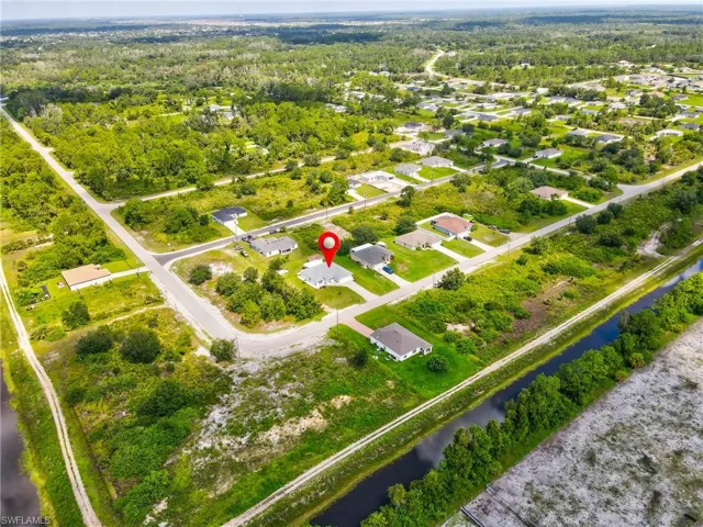 Aerial overview of property's location with a large body of water