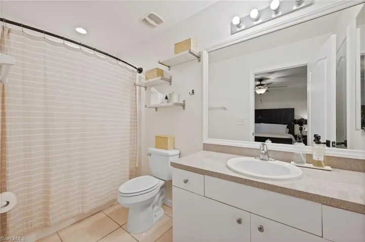Full bathroom featuring a vanity with an integrated sink, ample counter space, and under-sink cabinetry