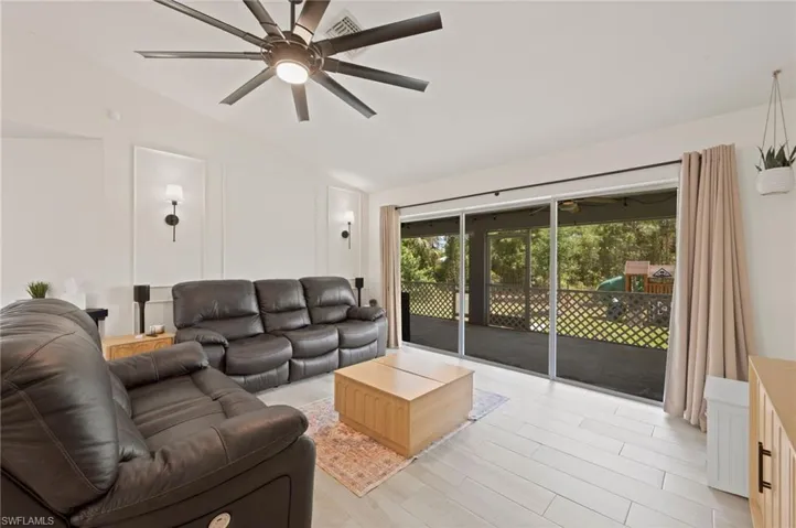 Spacious living area featuring vaulted ceilings and light-toned wood-finish flooring