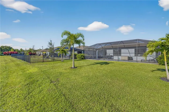 Fenced yard with a sunroom and a lanai
