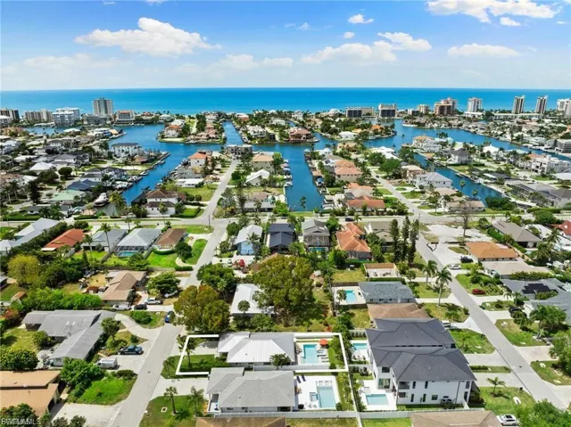 Aerial perspective of suburban area with a large body of water