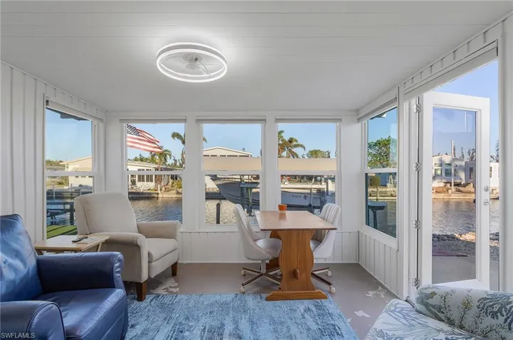 Sunroom featuring a water view and plenty of natural light