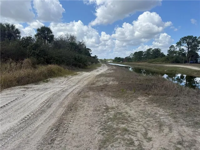 View of dirt / gravel road featuring a water view