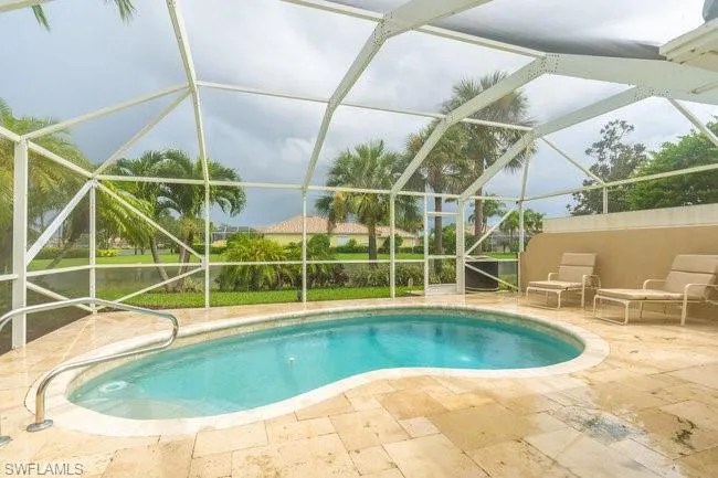 View of pool featuring a patio area and a lanai