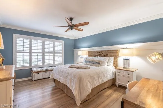 Bedroom featuring crown molding, ceiling fan, and light hardwood / wood-style floors