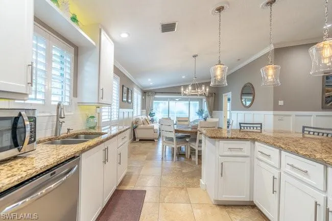 Kitchen featuring lofted ceiling, sink, a wealth of natural light, and stainless steel appliances