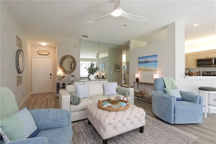 Living room featuring light hardwood / wood-style flooring and ceiling fan