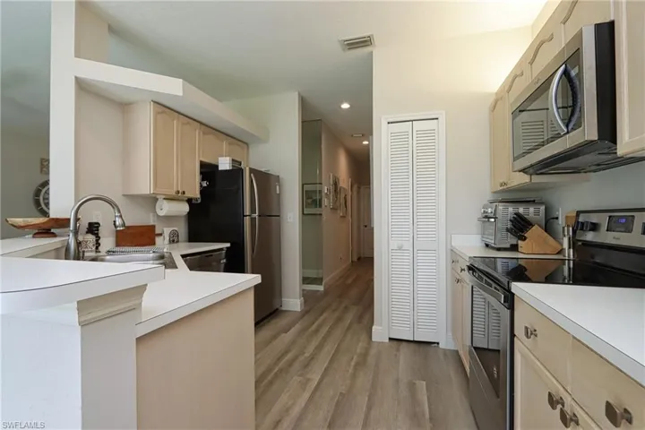 Kitchen featuring sink, light wood-type flooring, stainless steel appliances, and light brown cabinets