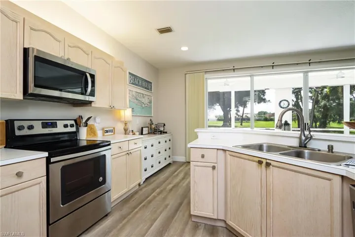 Kitchen featuring appliances with stainless steel finishes and light brown cabinetry