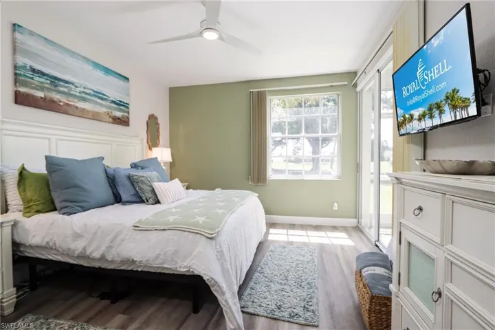 Bedroom featuring light wood-style floors, ceiling fan, and access to outside