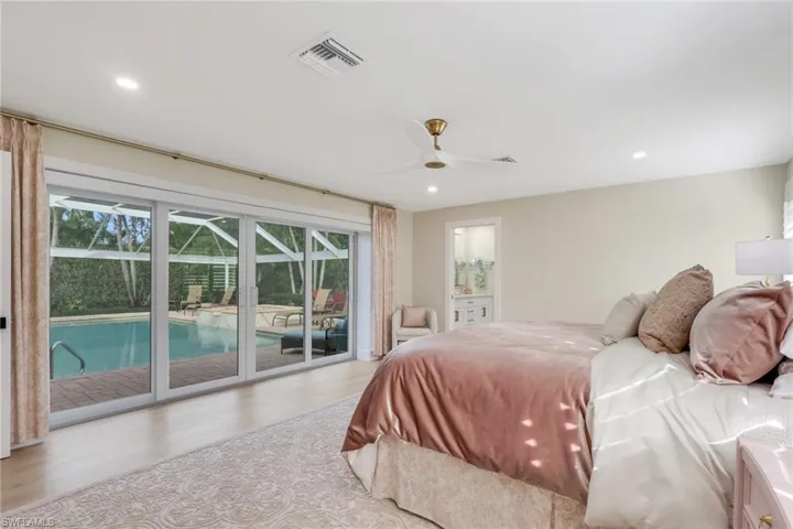 Bedroom with wood finished floors, access to outside, recessed lighting, ceiling fan, and a sunroom