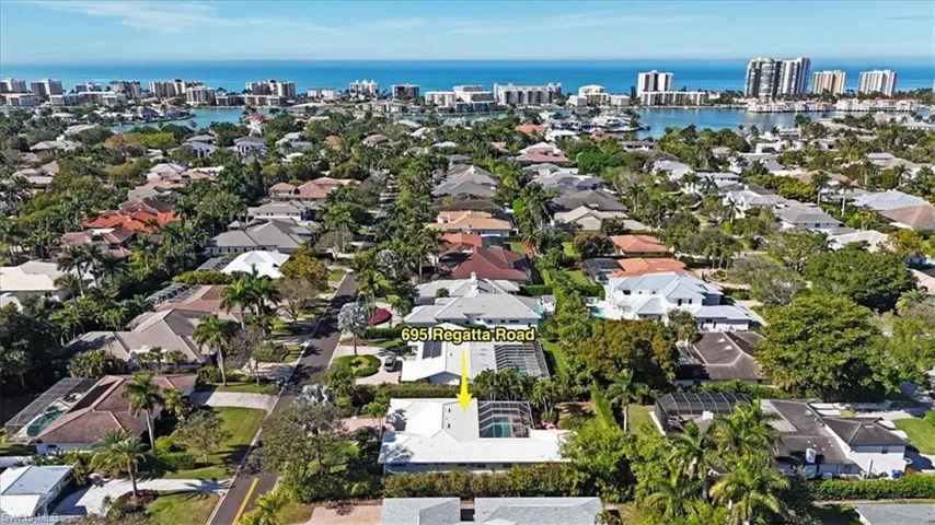 Aerial overview of property's location with nearby urban area and a nearby body of water