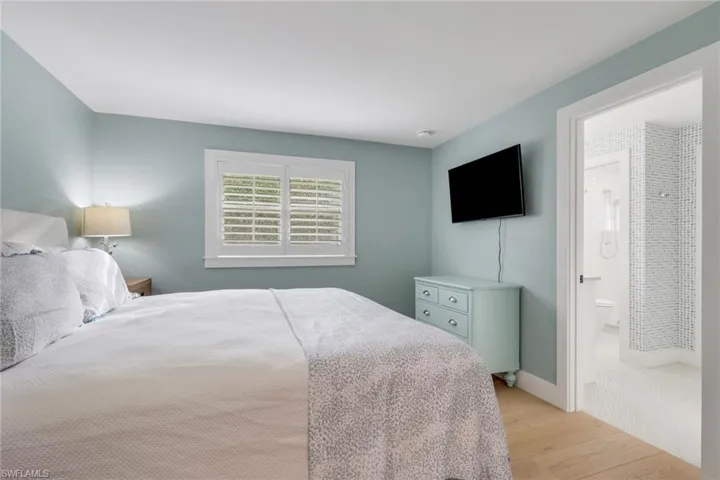 Bedroom with light wood-style flooring and baseboards