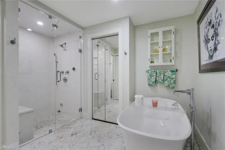 Bathroom featuring a freestanding tub and a stall shower