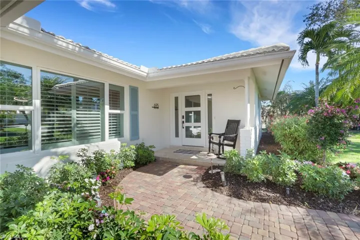 Entrance to property featuring stucco siding and covered porch