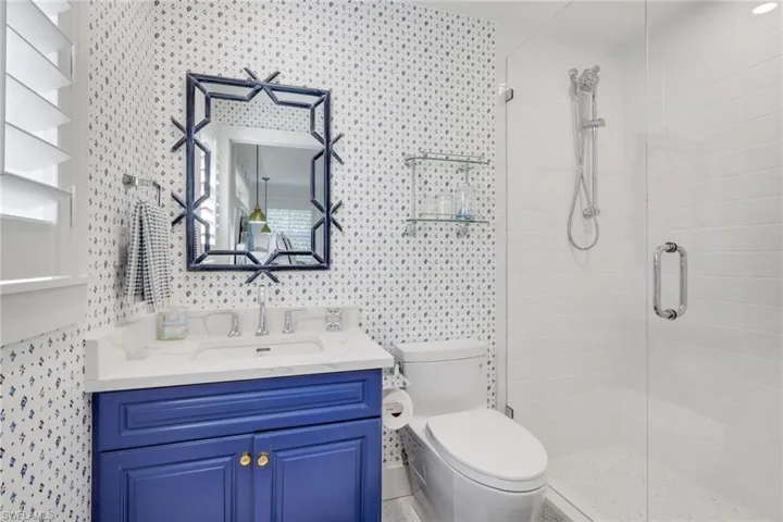 Full bath with vanity and a stall shower