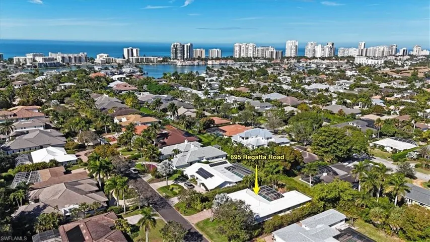 Aerial overview of property's location featuring nearby urban area and a large body of water