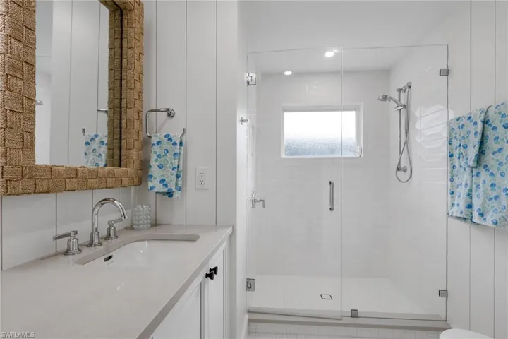 Bathroom featuring vanity, a shower stall, and recessed lighting