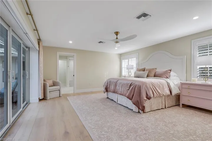 Bedroom with access to exterior, recessed lighting, a ceiling fan, and light wood-style floors