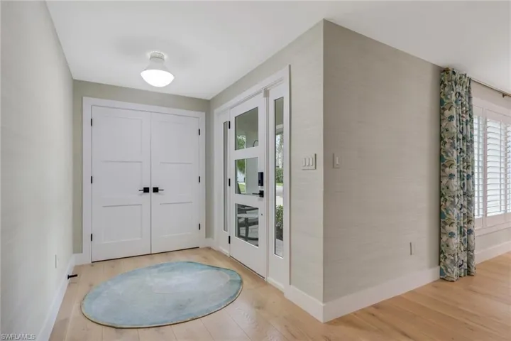 Entryway with light wood finished floors