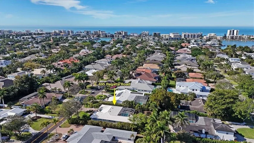 Aerial view of property's location featuring nearby urban area and a large body of water