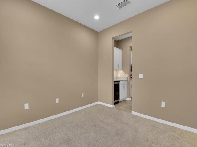 Den leading to Butler Pantry & Wine Fridge