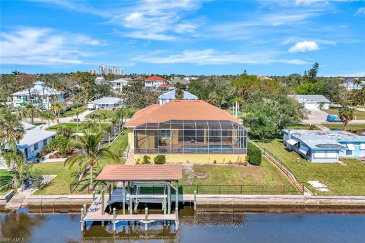 Birds eye view of property featuring a water view and a residential view