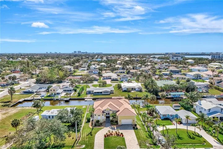 Birds eye view of property with a water view and a residential view