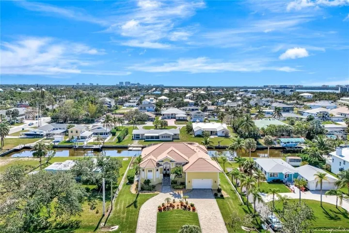 Drone / aerial view with a water view and a residential view