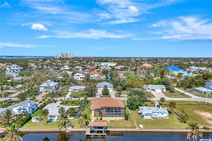 Drone / aerial view with a water view and a residential view