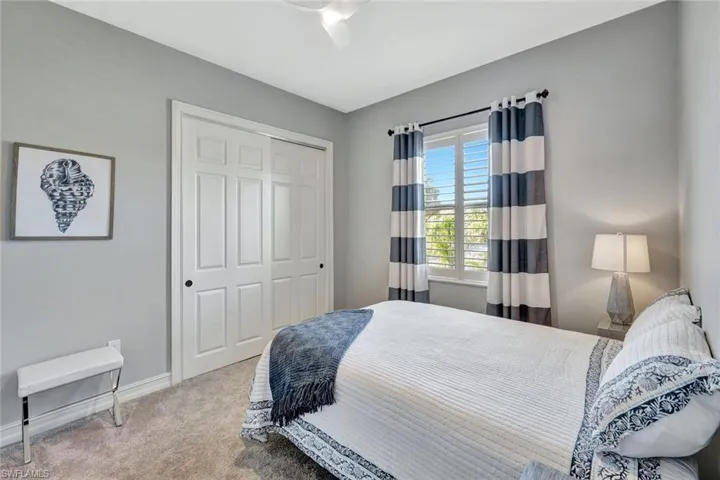 Bedroom featuring carpet floors, a closet, and baseboards