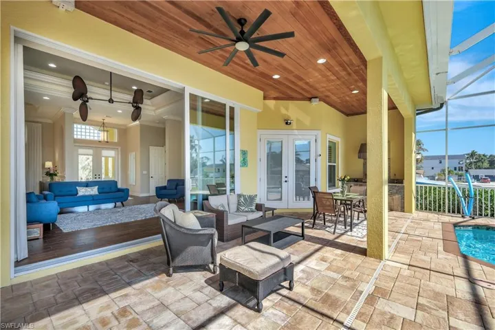 View of patio featuring an outdoor hangout area, french doors, a lanai, and a ceiling fan