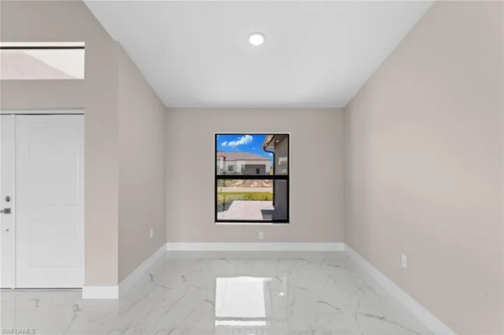 Spare room with light tile patterned flooring