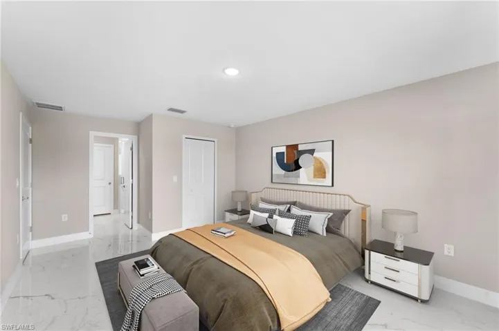 Bedroom featuring light tile patterned flooring and a closet