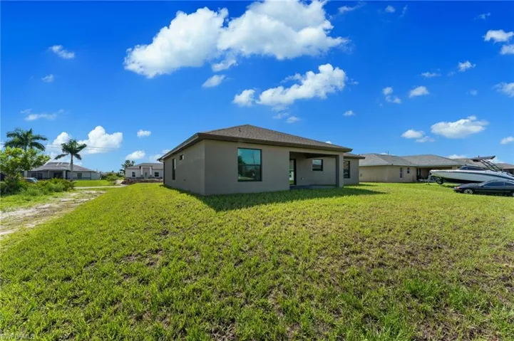 View of side of home featuring a yard