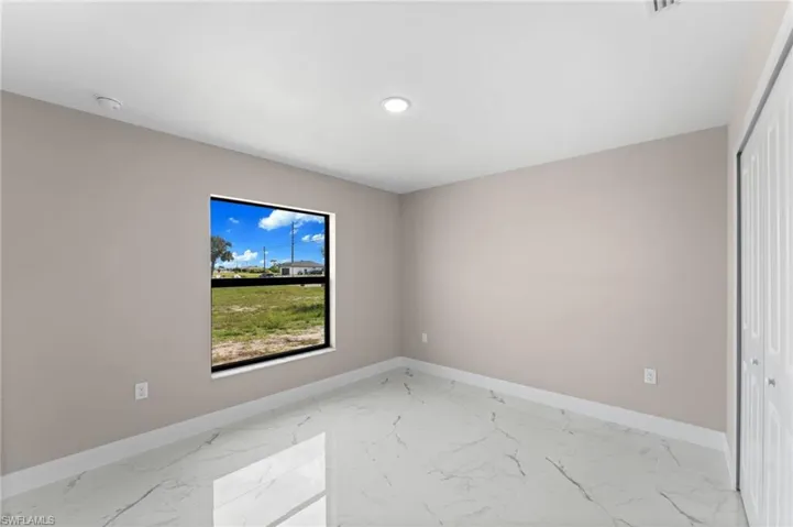 Unfurnished room with light tile patterned floors