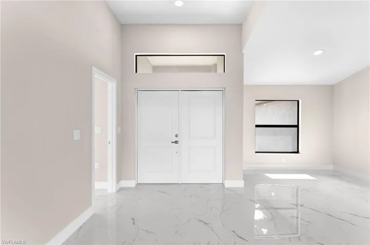 Entrance foyer featuring light tile patterned floors