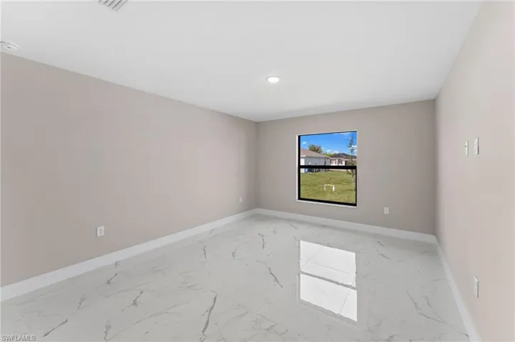 Empty room with light tile patterned floors