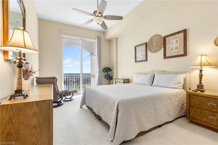 Spcious secind bedroom has a balcony and views of the downtown skyline and the lakes and golf course.
