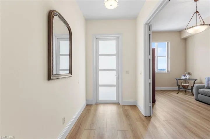 Custom 8 ft hurricane-rated entry door has frosted glass to let in more natural light.