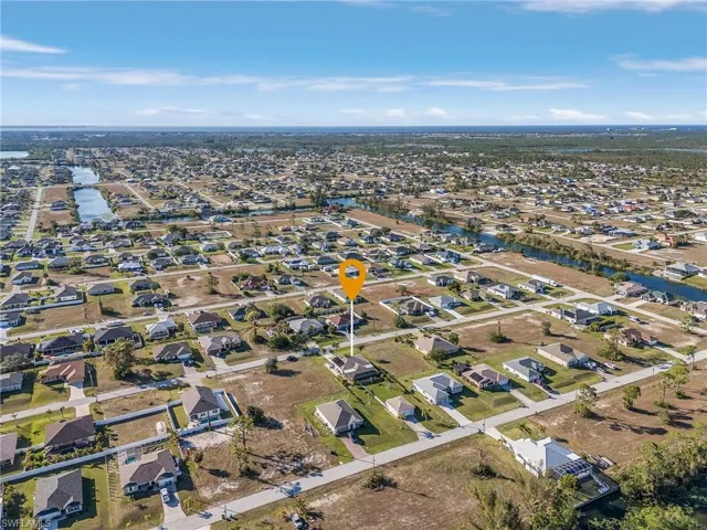 Aerial view of property's location featuring nearby suburban area and a large body of water