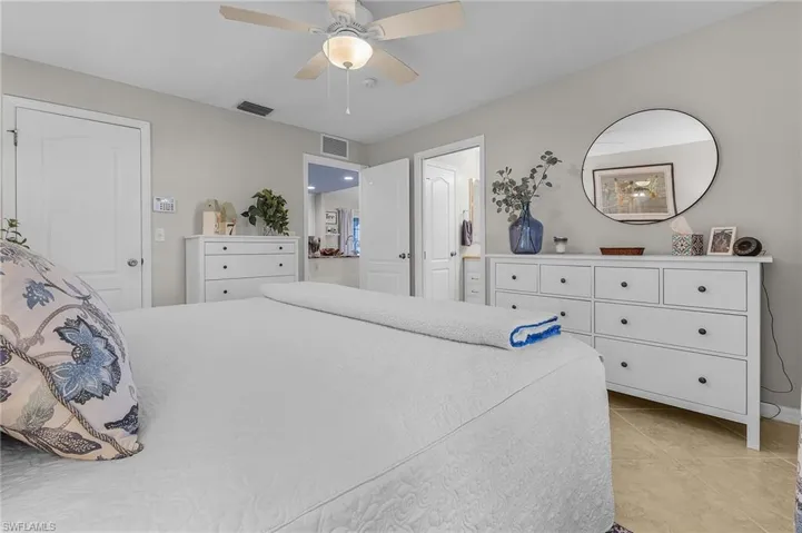 Bedroom with ceiling fan and light tile patterned floors