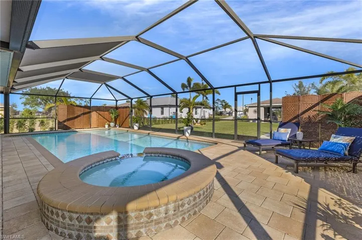 View of pool with a sunroom, a pool with connected hot tub, a lanai, and a patio