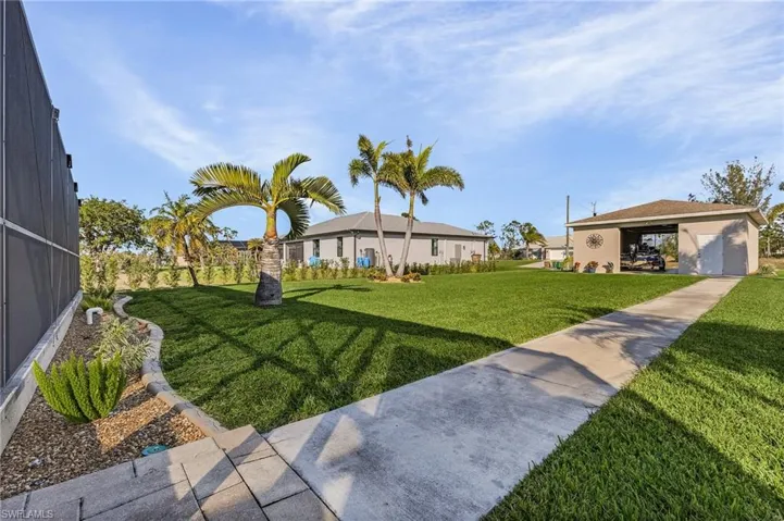 View of grassy yard featuring a lanai
