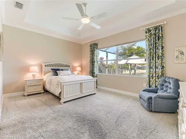 The large primary suite has an amazing pool and lake view