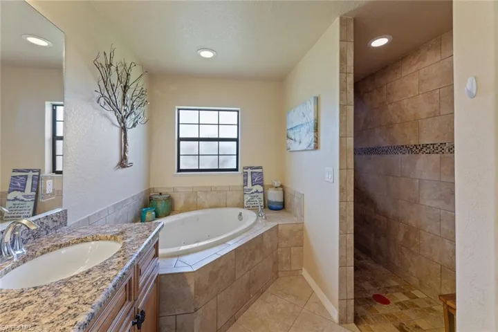 Owners bathroom with separate tub and walk in shower