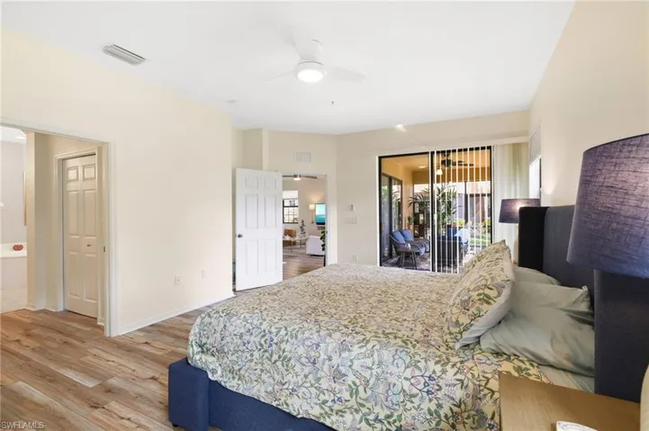Bedroom with light wood finished floors, access to exterior, and a ceiling fan