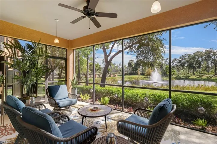 Sunroom / solarium with a ceiling fan, an outdoor living space, a water view, and healthy amount of natural light