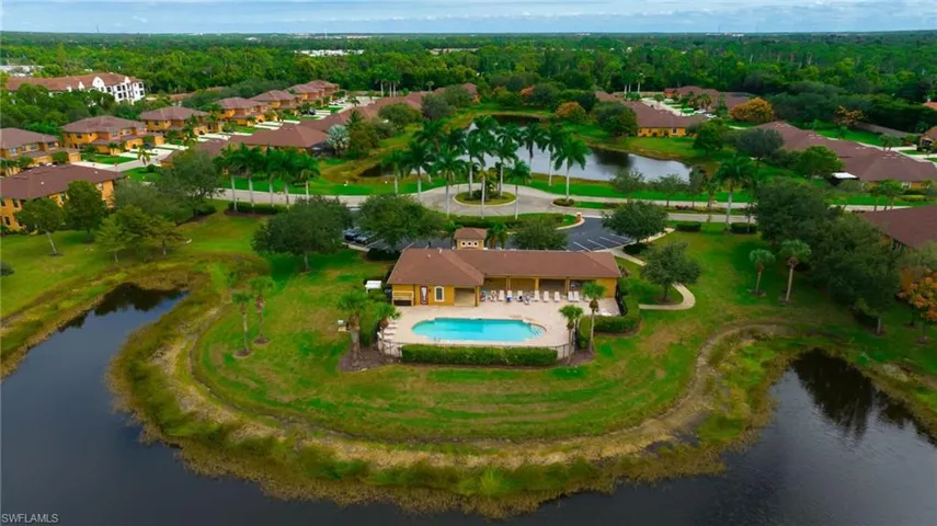 Aerial overview of property's location featuring a nearby body of water and nearby suburban area